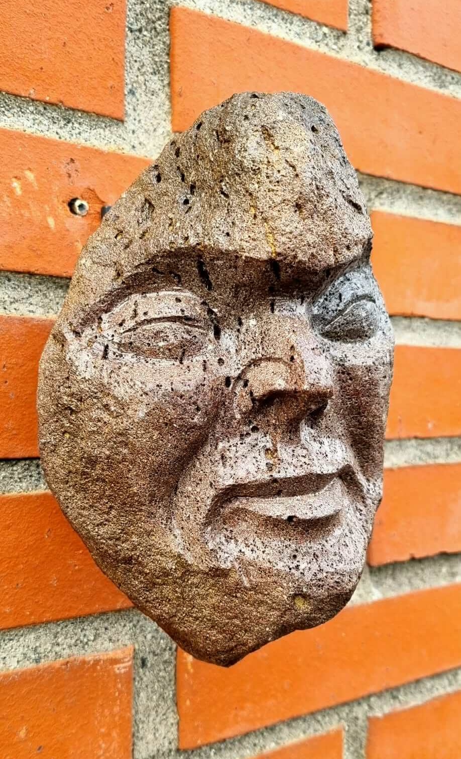 Half-revealed face carved into Icelandic rock by Jón Adólf Steinólfsson